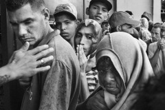 People wait in line for a free meal at Casa de Paso Divina Providencia, a charity organization run by the Catholic Diocese of Cucuta, in Villa del Rosario, Colombia, on June 25, 2018. Since March 2020, as a lockdown to prevent contagion was imposed in Colombia, community refectories have been closed, making it more difficult for charity organizations to reach the migrants and offer them food in the streets. According to the diocese's figures, the distribution of daily meals dropped from 13 thousand by 2019 to 1500 in 2021 and 2022.
In 2020, the photographer continued to monitor the increasingly harsh living conditions of Venezuelan refugees and migrants coping with the pandemic via video interviews, made possible by the cooperation of workers at Casa de Paso.
Each photo of this body of work received the prior or posterior consent of the people depicted.