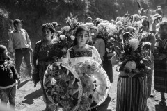 People from the community walk towards the Tuilelen's cemetery to bury Rivaldo Jimenez Ramirez, Santa Cristina Garcia, and Ivan Gudiel Pablo in Comitancillo, Guatemala, on March 14, 2021. 
On January 22, 2021, nineteen charred bodies were found on a country road in Tamaulipas, Mexico's northeastern state bordering the United States. Sixteen of the victims were Guatemalan, thirteen from the same village, Comitancillo, and the others were of Mexican descent. The bodies were inside a pickup truck, hit by 113 bullets, and burned.  
The massacre, according to investigators, would be linked to a dispute between criminal groups to control the migrant routes. Twelve police officers are under trial for allegedly having committed the crime.
The photographer traveled to Comitancillo to visit the families of the victims, and document the funerals. 
Thousands of people, consumed by grief, buried relatives and friends as if burying the hope that a better future was possible.
The community welcomed journalists and photographers in their homes and during the three-day funeral processions hoping that, by the world knowing their suffering, such an event would not occur again.