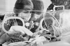 A Venezuelan couple observes their newborn in an incubator at the Erasmo Meoz Hospital in Cucuta, in North Santander, Colombia, on May 22, 2018. 
As Venezuelan consulates and the embassy in Colombia closed in 2018 because of the political frictions between the two countries, it has been impossible for undocumented Venezuelans to claim citizenship, either Venezuelan or Colombian, for their babies.
In 2021, the Colombian government announced a new statute that could regularize almost a million Venezuelans, including children, adolescents, and newborns.
The lack of medicines and doctors in Venezuela worsened healthcare conditions and put childbirths at risk. According to government data reported by Venezuelan media in 2017 (for which the Health Ministry refused to comment), infant mortality and maternal deaths increased by over 65% from 2015 to 2018. 
Pregnant women and young girls leave the country to give birth in Colombia. 
The Erasmo Meoz Hospital’s director, and the people depicted in the photograph, granted the photographer access to work.