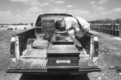 Luis Arevalo, who migrated from Venezuela to Colombia in search of job opportunities, sits in the back of a pickup truck, mourning his sister Luisana in Riohacha, Colombia, on August 17, 2018. 
She died asphyxiated in a car, and her family could not afford the cost of repatriating the body to Venezuela. Luisana’s mother could travel to Colombia to assist with the funeral in a private cemetery, thanks to the support of a local NGO. 
In recent years, so many dead bodies in the streets at night ended up in the crowded city's cemeteries. Without registering, people often bury the dead in uncultivated fields out of the city line. Of many with no name, there will be no trace left. It will be impossible for their families in Venezuela to know what happened to them and find or repatriate the remains.
Luisana's relatives agreed that the photographer would document the funeral to shed light on their struggles. "I used to believe in the revolution, but now the world must know what Maduro is doing to the people of Venezuela," -Luisana's mother said.