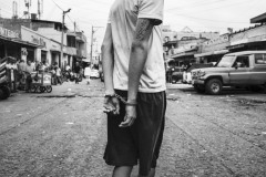 Police arrest a Venezuelan boy accused of theft in Maicao, La Guajira, Colombia, on August 15, 2018. 
The poverty and the precarious living conditions in the migrants' settlements and the border towns' streets push some into criminal survival strategies. Because of the pandemic, a greater social instability has hit Colombia, and xenophobia has risen. Colombian citizens are concerned about migrants gathering in the streets, informal camps, and migration routes because that could spread the virus.
The photographer's attention was caught by the scene of this young boy detained while working close to the city market.