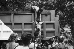 A group of migrants climbs the wall of a coal truck whose driver offered them a ride in Pamplona, in North Santander, Colombia, on October 10, 2018.
Along the Andean route connecting the Cucuta border city to Bucaramanga and the capital city Bogotà, temperatures are challenging for Venezuelan migrants, used to the much wormer Caribbean climate. The journey on foot can last weeks, and international aid is scant, far from the media's eyes, focused on the main border cities. At night, people find refuge in warehouses offered by Colombian citizens.
The people in the photograph had found refuge in an abandoned house that an American NGO was rebuilding as a charity shelter. The photographer was interviewing and photographing these families when a nearby woman told a truck driver had agreed to transport them to Bucaramanga. A religious fanatic, the woman insisted that they prayed before leaving, yelling at them that their condition depended on their sins and their faith in Venezuelan socialism. 
The photographer worked with the people’s consent.